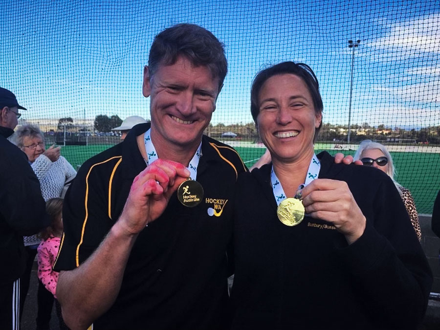 DOUBLE GOLD 
Shane as 50s coach and Emma playing for Western Australia 40s hockey team show off their gold medals at a national interstate tournament